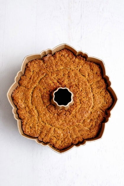 Baked apple cider bundt cake in a bundt cake pan.