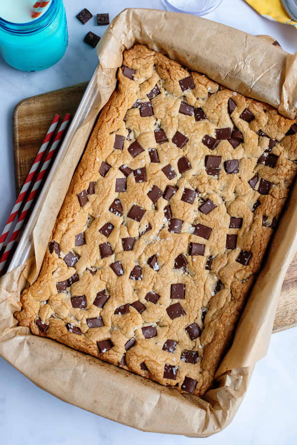 Chocolate chip cookie bars in a baking sheet fresh out of the oven.