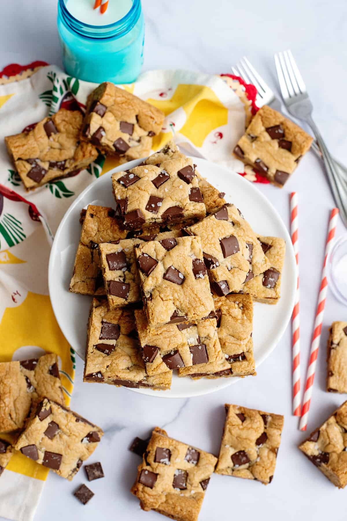 Chocolate chip cookie bars scattered on a plate.