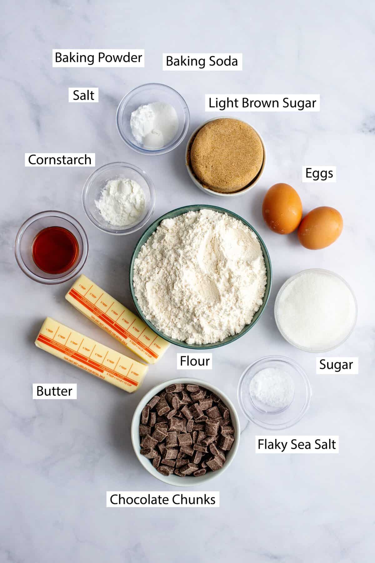 Ingredients for chocolate chip cookie bars, featuring butter, light brown sugar, granulated sugar, eggs, vanilla, all-purpose flour, cornstarch, baking soda, baking powder, salt, and semi-sweet chocolate chips.