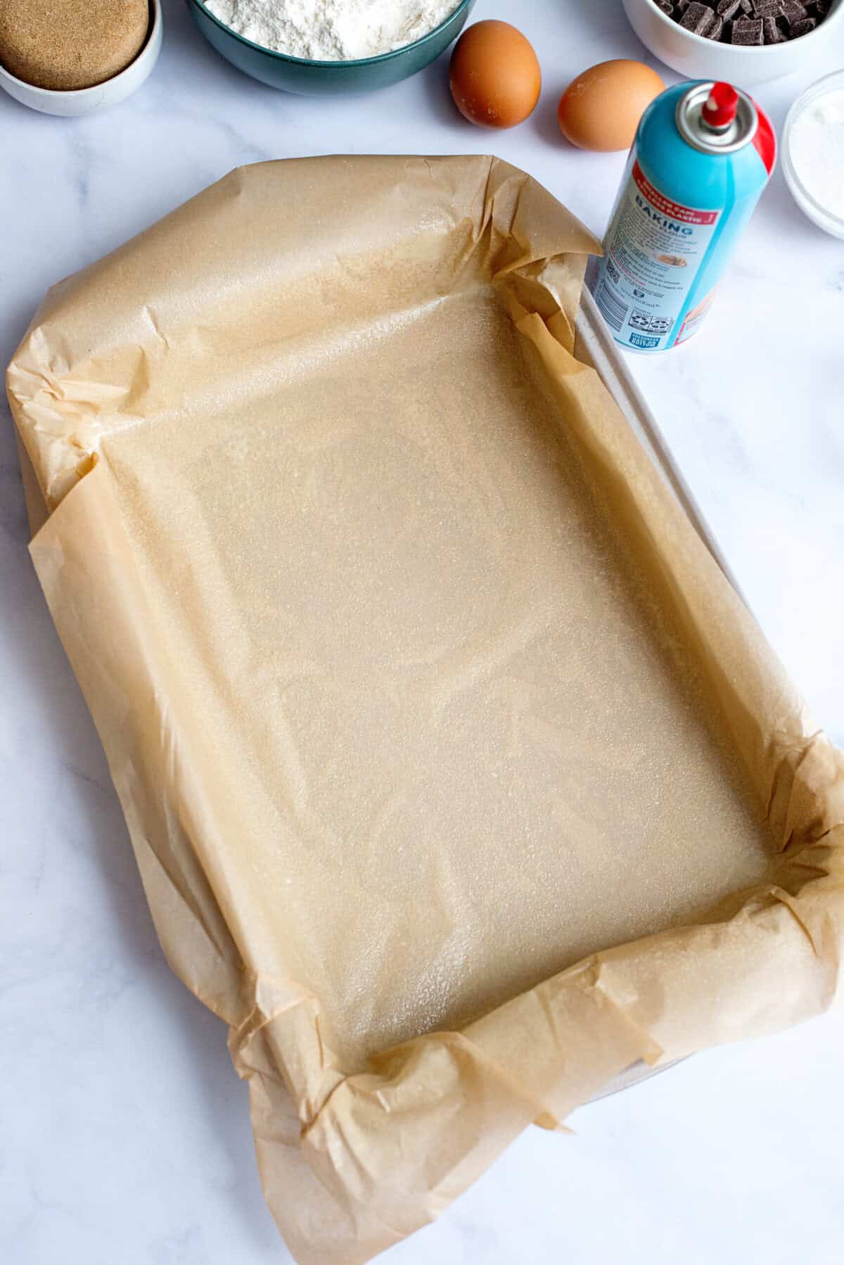 A baking pan lined with a sheet of parchment paper.