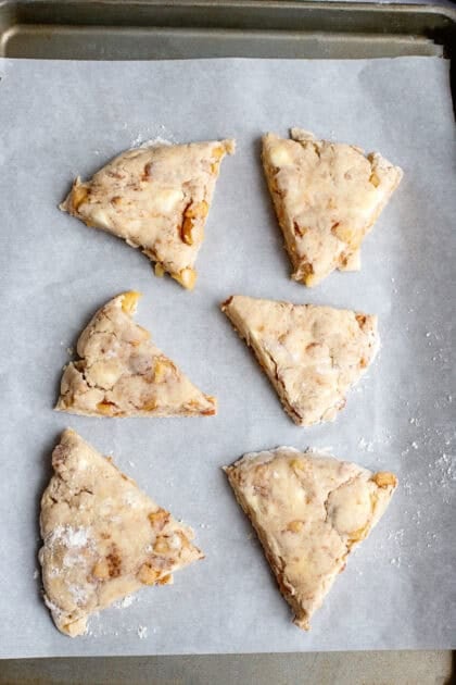 Apple maple bakery scones on a baking sheet ready to bake.