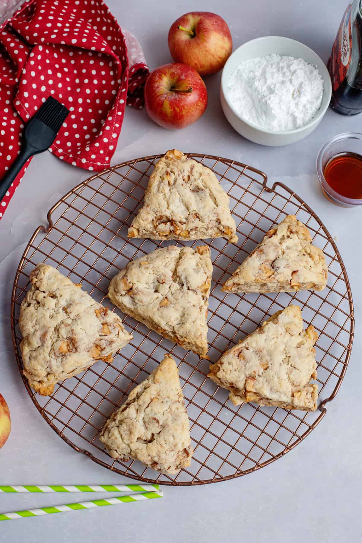 Apple maple bakery scones on a cooling rack.