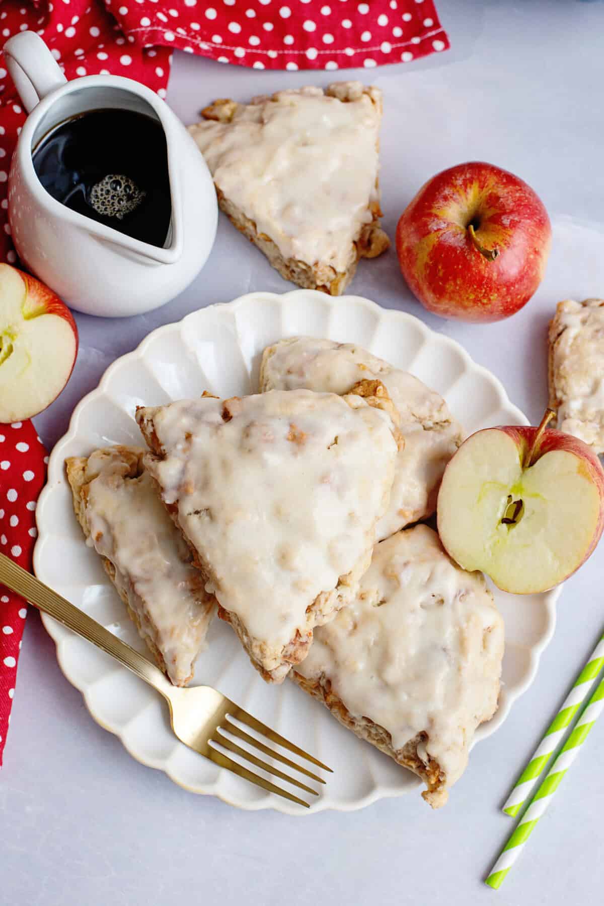Glazed apple maple bakery scones on a white plate.