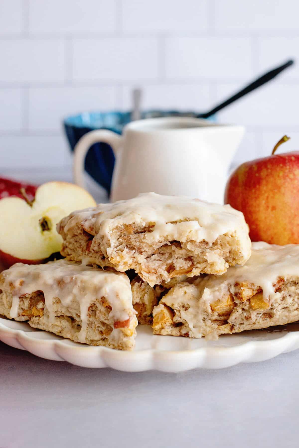 A stack of apple maple bakery scones on a white plate.