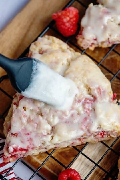Brushing glaze onto a raspberry scone.