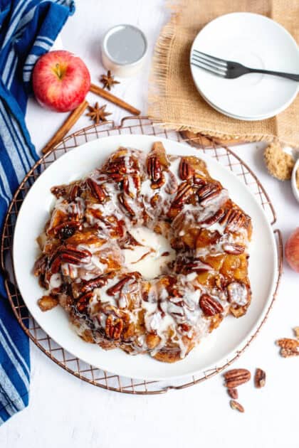 Apple pie cinnamon roll monkey bread on a white plate.