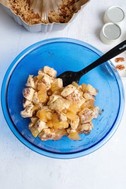 Cinnamon roll pieces mixed with apple pie filling.