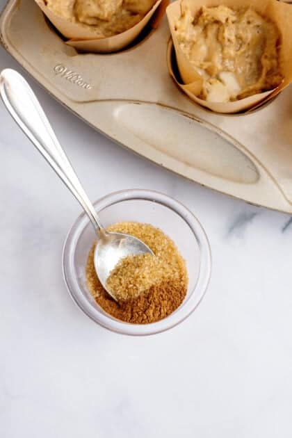 Cinnamon sugar in a small glass dish with a spoon.
