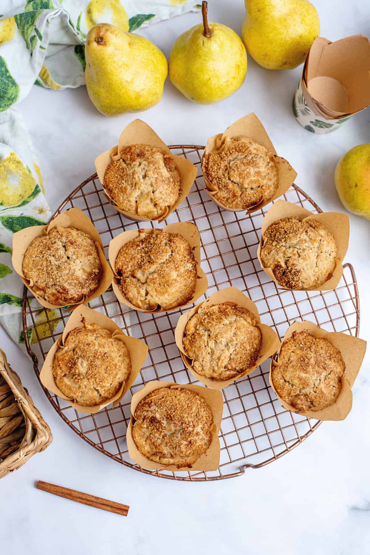 Brown butter pear muffins on a cooling rack.