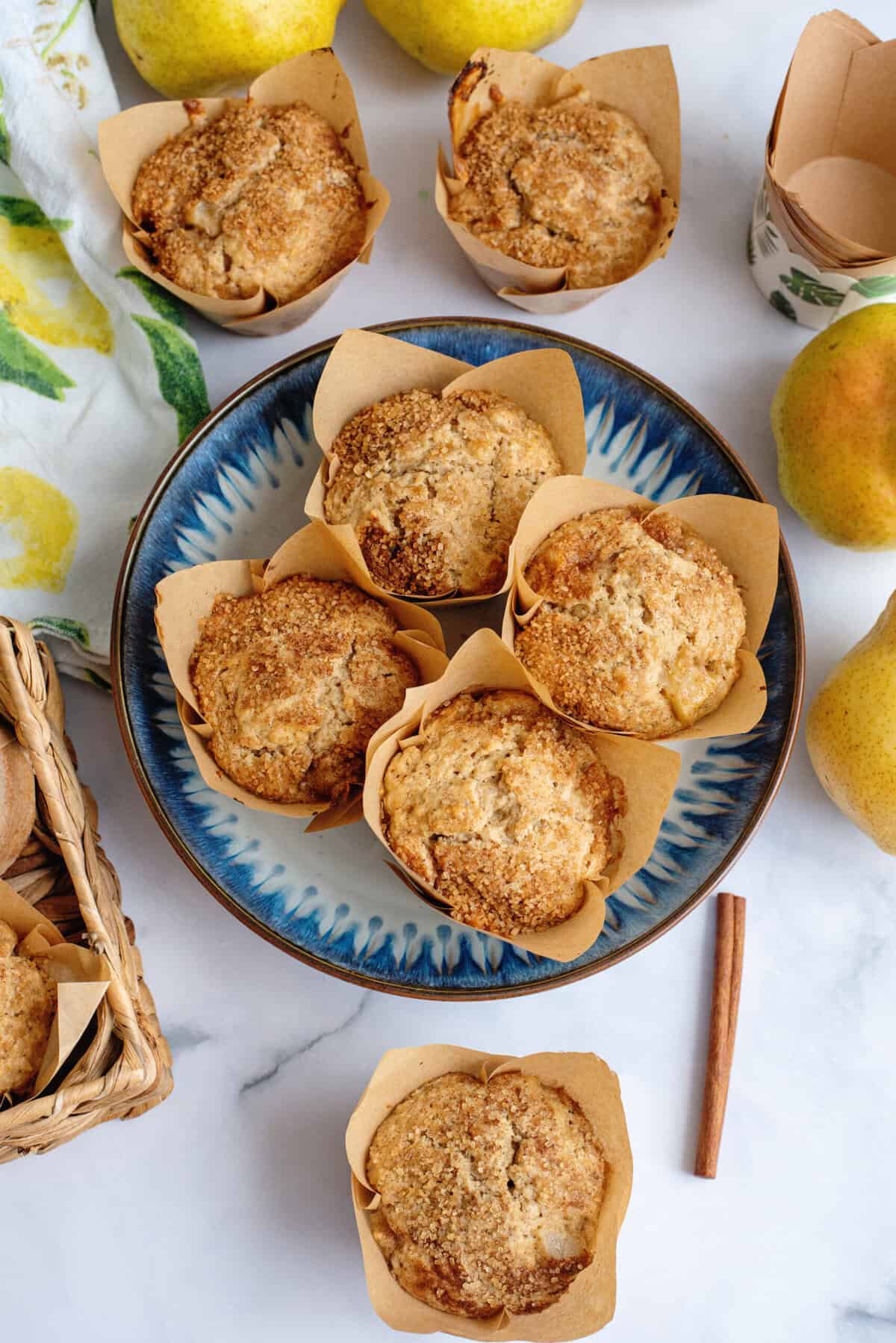 A pile of brown butter pear muffins on a plate.