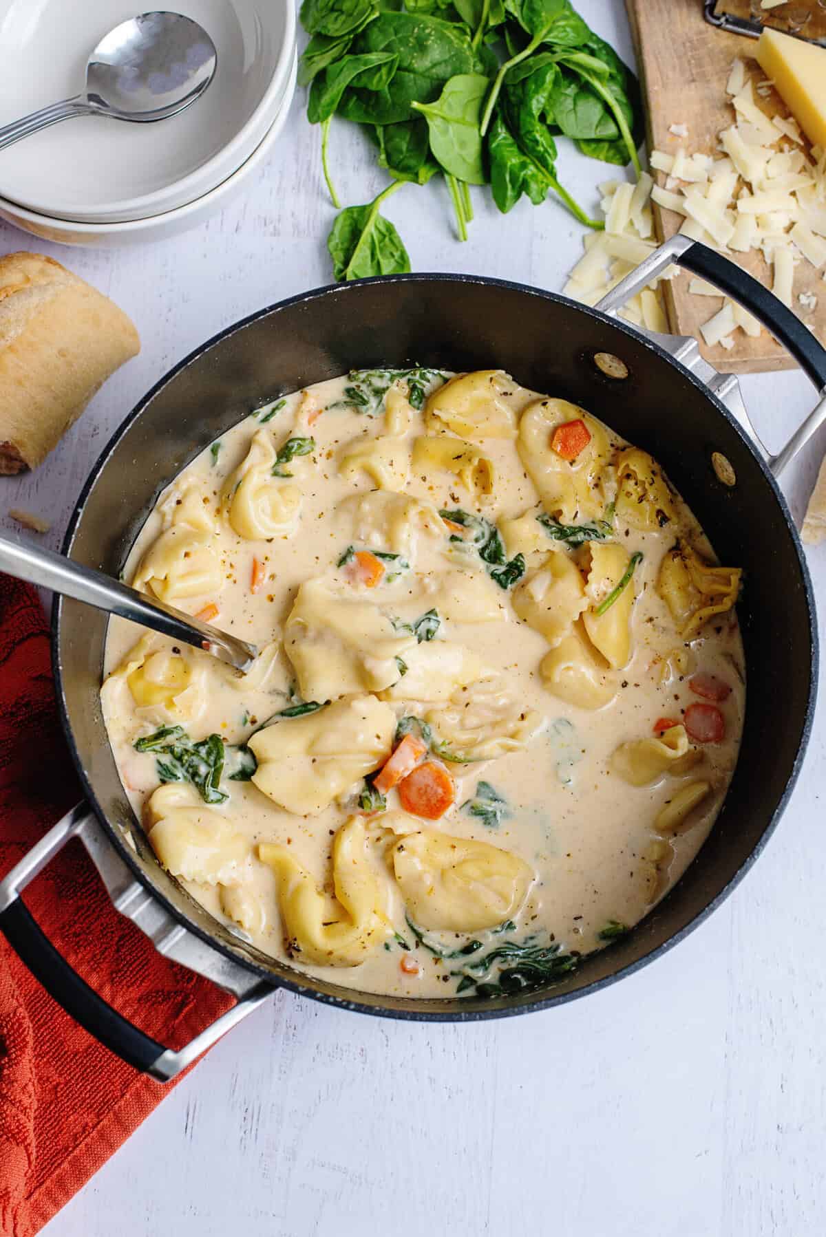 Creamy tortellini soup in a pot.
