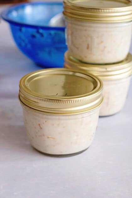 Overnight oats in three mason jars with the lids closed.