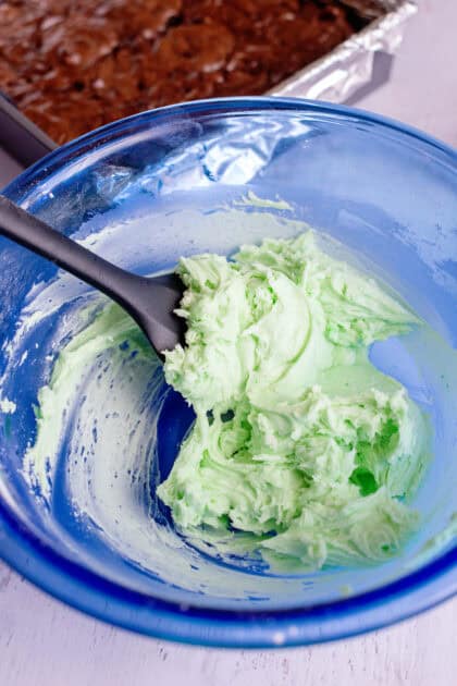 Minty green filling in a glass blue mixing bowl.