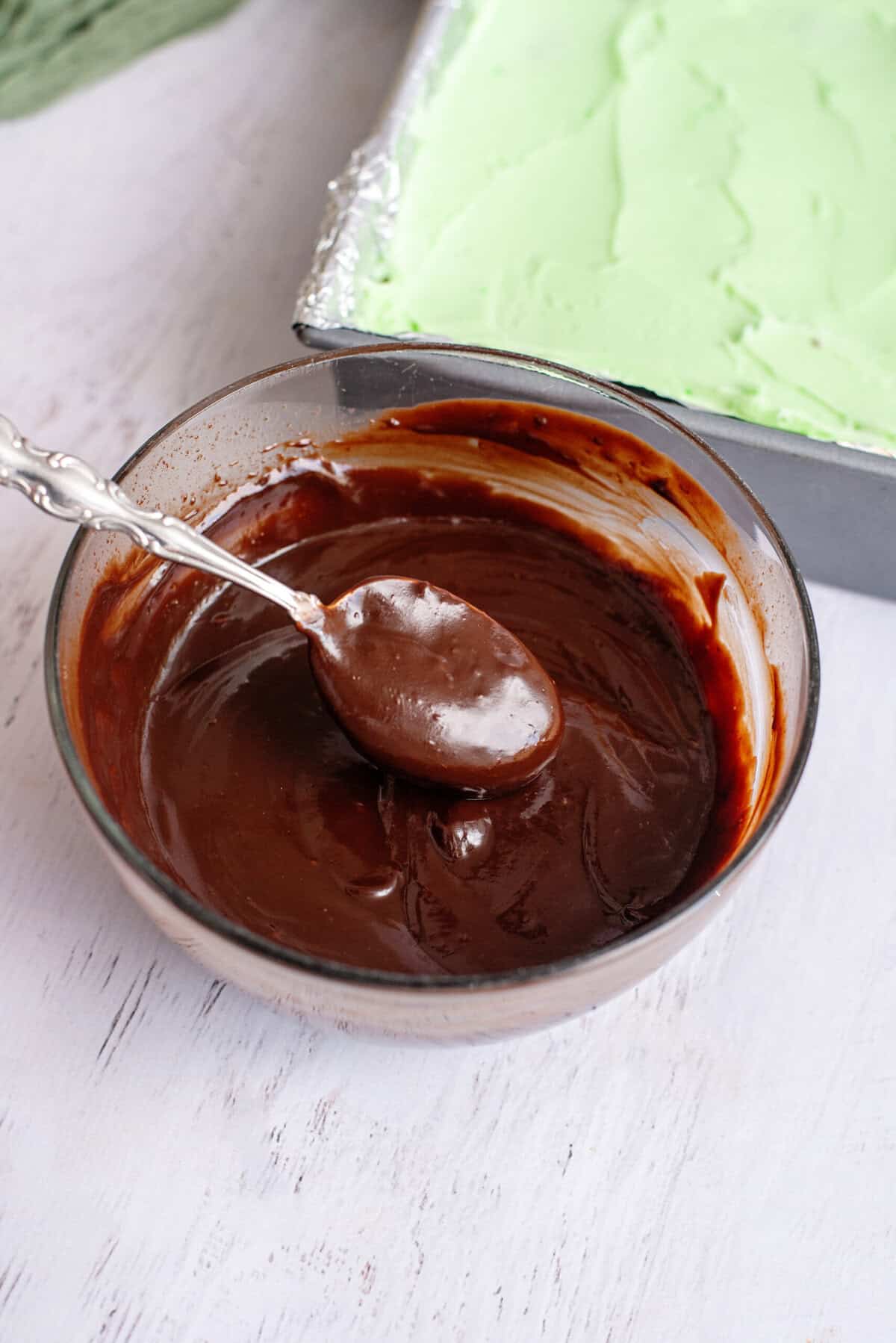 Chocolate ganache in a glass mixing bowl.