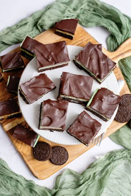 Scattered grasshopper brownies on a cake tray.