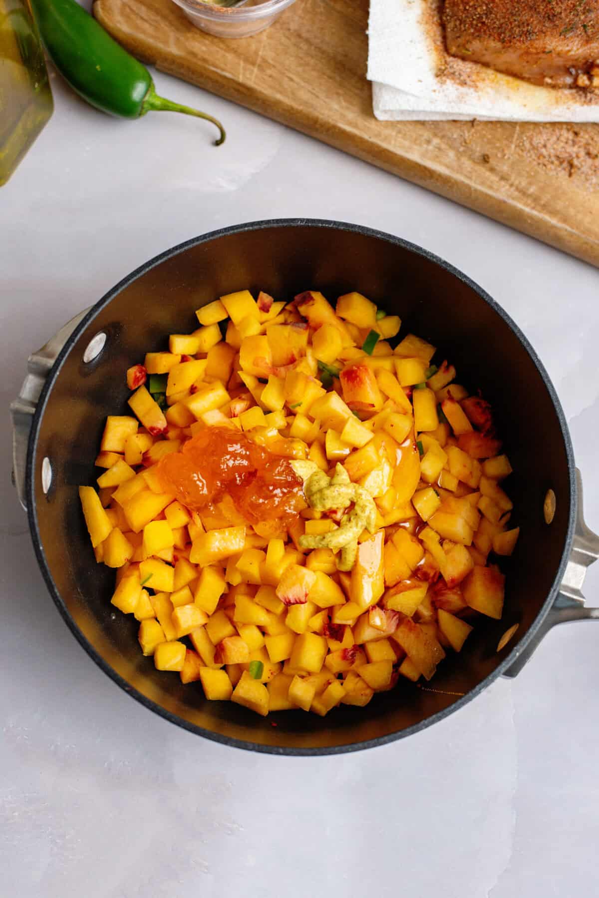 Peaches, jalapeño, peach preserves, honey, apple cider vinegar, Dijon mustard, and salt in a small saucepan.