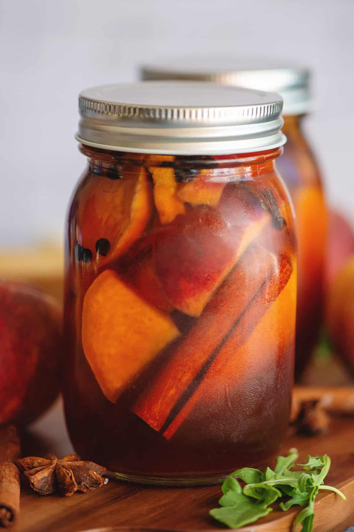 Pickled peaches in a mason jar.