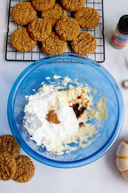 Making cream cheese filling in a glass blue mixing bowl.