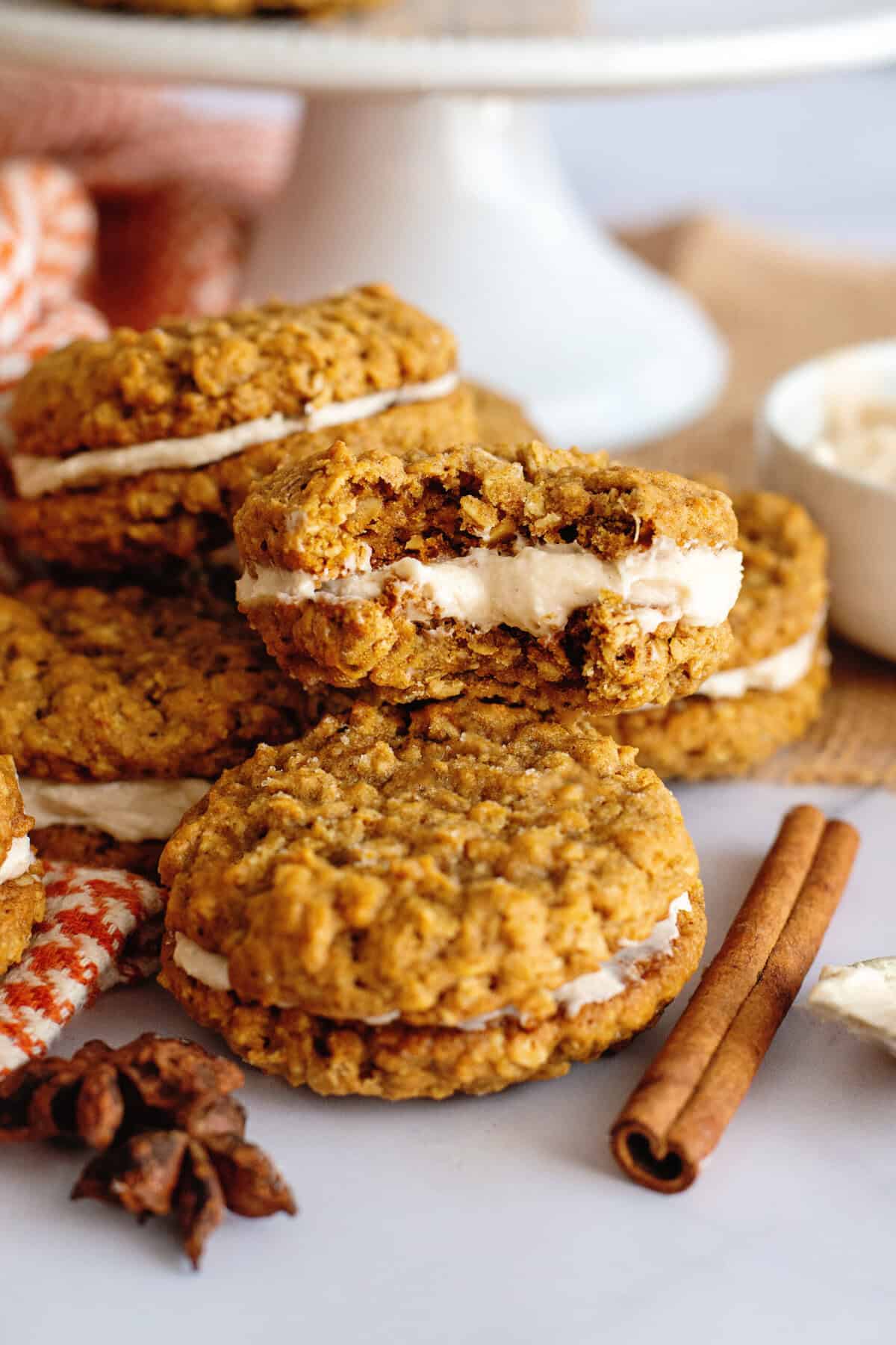 A stack of pumpkin oatmeal cream pies, one with a bite taken out of it.