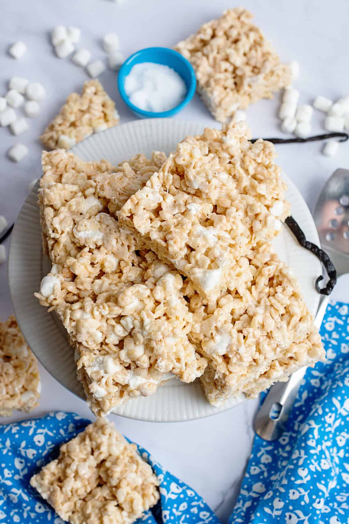 A stack of Rice Krispie treats on a cake stand.