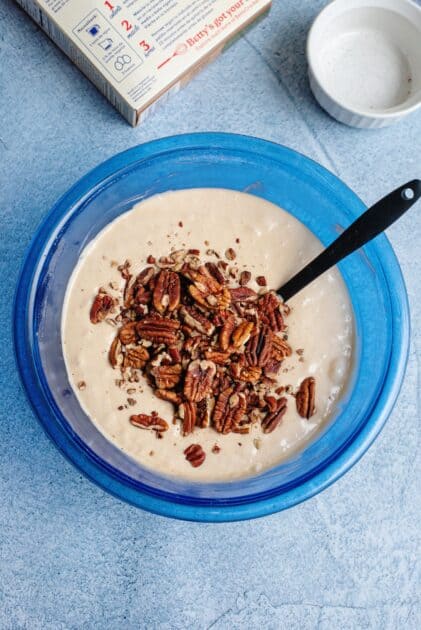 Adding chopped pecans to butter pecan muffin batter