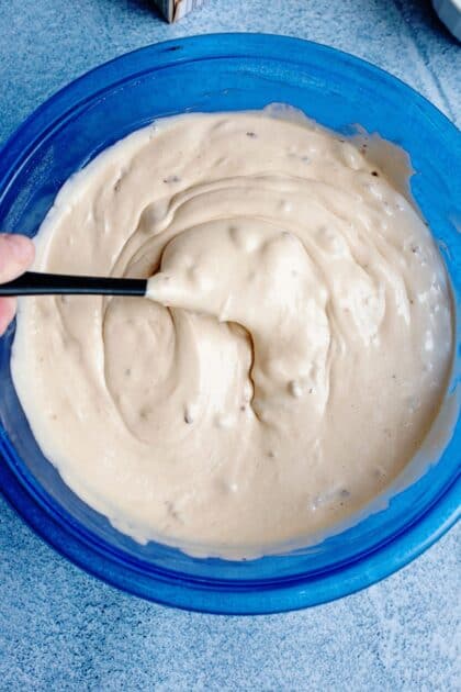 Butter pecan muffin batter in a blue mixing bowl