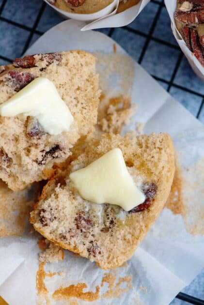 Butter pecan muffin split open with butter