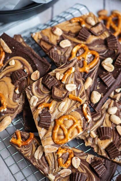 Peanut butter chocolate bark topped with pretzels and peanut butter cups