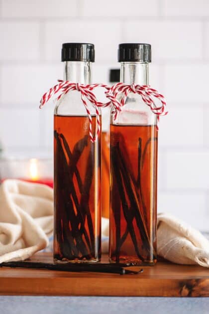 Two bottles of homemade vanilla extract tied with red and white twine