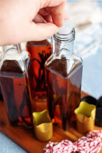 Adding stoppers to bottles of homemade vanilla extract