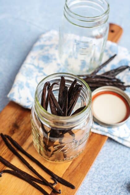 Split vanilla beans standing in a mason jar