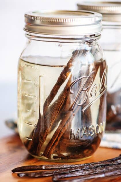 Vanilla beans just starting to steep in vodka in a mason jar